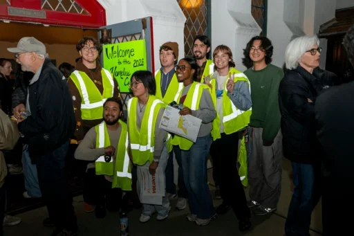 Volunteers equipped with reflective safety vests pose together