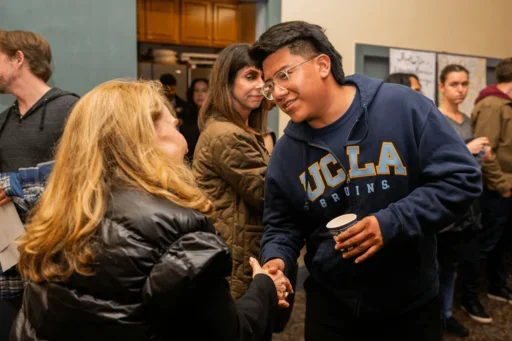 Knaul shaking hands with a UCLA student