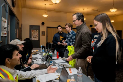 A volunteer returns his supplies alongside other volunteers.